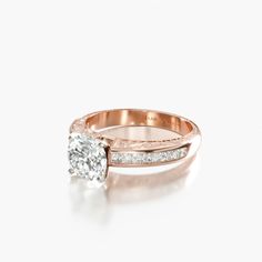 a rose gold engagement ring with an oval cut diamond in the center and side stones