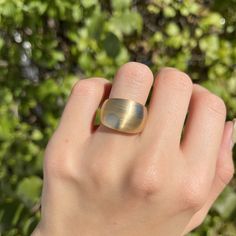 Vintage 18KT yellow gold + white gold mid-century modernist domed cigar band ring with circles design. Matte-finished, dual metal gold, with yellow gold band and white gold circles. A rare, absolutely statement-getting piece made in high-quality 18K gold! A ring with pedigree- originally purchased from premier Minneapolis, MN jeweler, Morgan Jeweler's, circa 1970's. Coordinating bracelet sold separately. Beautiful, chunkiness to this piece! Size 5.25 Width: 14mm at widest point ~5mm (back band) Modern Yellow Gold Domed Signet Ring, Modern Yellow Gold Dome Ring With Polished Finish, Modern Yellow Gold Dome Ring, Modern Yellow Gold Rounded Dome Ring, Modern Gold Dome Ring For Anniversary, Modernist Oval Gold Jewelry, Modern Gold Wide Band Oval Ring, Modernist Oval Gold Rings, Modernist Dome Ring With Polished Finish