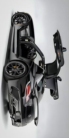 a black motorcycle with wheels on the back is shown from above in this artistic photograph