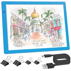 a drawing pad with four usb cables attached to it and an image of a mosque in the background