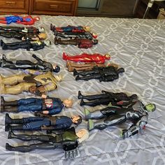 toy action figures laid out on a bed