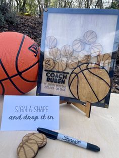 a table with a basketball, marker and sign on it