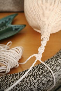 a close up of a banana on a table with some string attached to the end