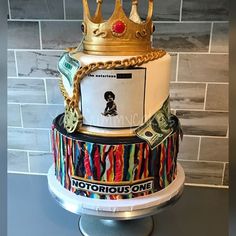 a multi - tiered cake decorated with money and a crown on top is shown