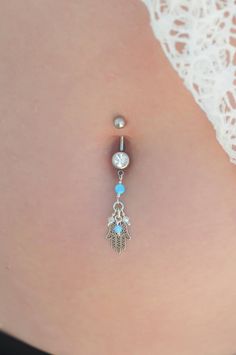 "A Hamsa belly button ring made with dangling light blue Opal stones and white Swarovski beads. This navel piercing is handmade of a Silver barbell, Hamsa hand pendant, and light blue Opal stones. The Hamsa (or Hand of Fatima) is a middle-eastern symbol of good luck, said to keep evil spirits away. Do not hesitate to contact me for special requests and customization! ♥♥ ▶ Sterling Silver curved barbell, 11 mm long for a universal fit. ▶ Delicate silver chain ▶ Light Blue Opal stones and white Sw Piercing Navel, Button Piercing, Hand Pendant, Hamsa Pendant, Navel Ring, Navel Piercing, Swarovski Beads, Belly Piercing, Belly Button Piercing