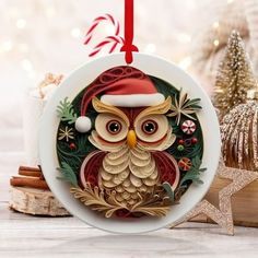 an ornament with an owl wearing a santa hat