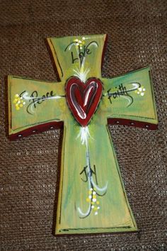 a painted cross with a heart on it