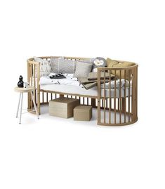 a baby crib that is next to a table