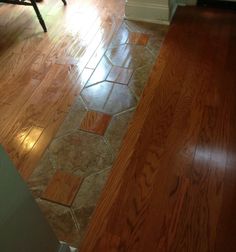 a wooden floor with tile on it in a room