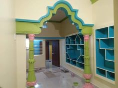 an archway in the middle of a room with blue and green paint on the walls