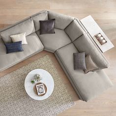 an overhead view of a living room with couches and coffee table on the floor