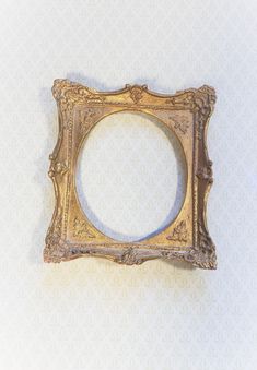 an ornate gold frame on a white background