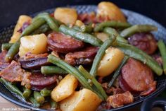 a plate full of potatoes, green beans and sausage