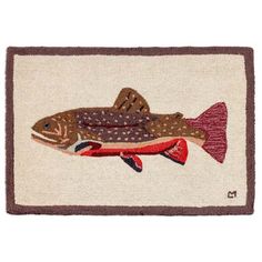 a fish hooked up to a hook on a door mat that is white and brown