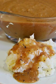 a plate with mashed potatoes and gravy on it