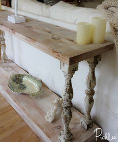 a wooden table with candles on it next to a couch