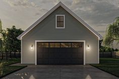 a garage with two lights on the side of it and a driveway in front of it