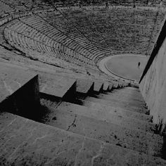 an empty stone arena with steps leading up to it