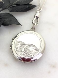 A Lovely 1920's Art Deco Sterling Silver Round Locket.  This is quite a heavy solid silver locket, with beautiful hand engraved design on the front.  It is stamped on the back SILVER.  The locket is in perfect working condition, it opens and closes perfectly with a Click!  Inside it has one original frame and space for two photos.  The locket measures 1.3 inches including the top jump ring.  It's hanging from a new Sterling Silver Swivel Dog Clip.  It's all on a new Sterling Silver 18 inch curb 1920 Art Deco, Sterling Silver Locket, Round Locket, Silver Locket, Dog Clip, 1920s Art, 1920s Art Deco, Silver Lockets, Locket Necklace