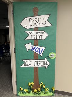 a door decorated with a sign that says jesus will always point you in the right direction