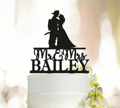 a wedding cake topper that says mr and mrs bailey with a bride and groom silhouette