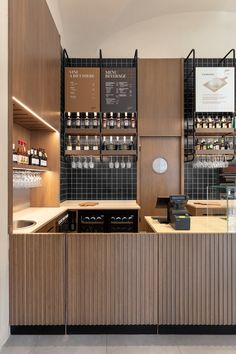 an empty bar with lots of bottles on the wall and counter tops in front of it