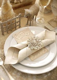 a white plate topped with napkins and silverware on top of a wooden table