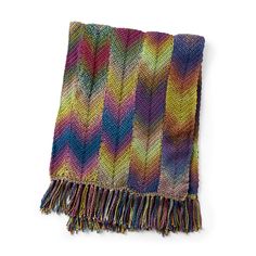 a multicolored knitted blanket with fringes