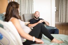 a man sitting in a chair next to a woman