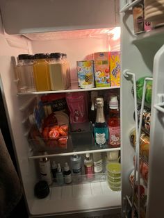 Open mini fridge stopped with skin care drinks and mini wine bottles. College Mini Fridge Food, Min Fridge In Bedroom, Mini Fridge Essentials, Mini Refrigerator Aesthetic, Meal Prep Mini Fridge, College Fridge Organization, Mini Fridge Bedroom Ideas, Rooms With Mini Fridge, Mini Fridge Aesthetic Food