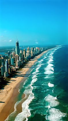 an aerial view of the beach and ocean in surfers paradise with high rise buildings