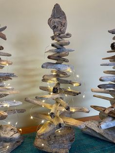 driftwood christmas trees with lights on them