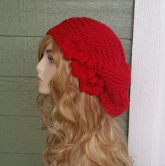 a mannequin head wearing a red knitted hat