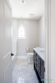 a bathroom with a toilet, sink and window