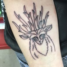 a tattoo on the arm of a woman with an owl's head and feathers