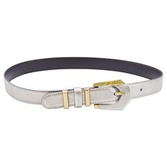 Gianni Versace thin waist belt from the early 1990s. Silver rigid leather with gold tone hardware. Gold on buckle features Greek key detailing. Belt loops are gold tone metal with a silver leather in between. Tonal silver top stitching. Black leather interior with contrasting gold brand stamp. Excellent vintage condition. Marked 30"/75cm, 1" wide. Made in Italy. Gold Belt, Gold Belts, Silver Belts, Silver Tops, Gold Branding, Greek Key, Gianni Versace, Leather Interior, Gold Tone Metal