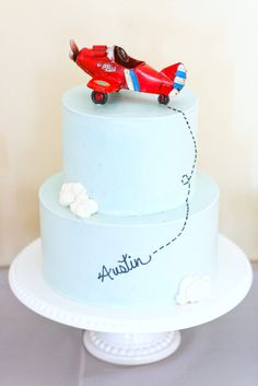 a blue cake with a red plane on top