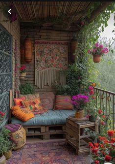 a porch with lots of flowers and plants on it