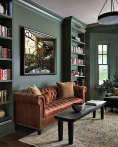 a living room filled with furniture and bookshelves