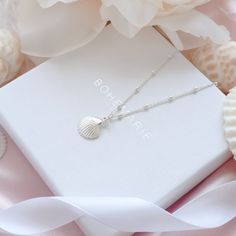 Silver Seashell Necklace Be inspired by our dainty and meaningful seashell necklace. Our silver seashell necklace represents beauty, good fortune and feminine energy. This minimalist necklace comes with an inspirational description card and is packaged in a branded Bohemarie gift box, making this necklace the perfect gift for yourself or a special loved one. Necklace Details: * Seashell Charm: 1.7 x 0.4cm * Chain Length: 40cm, 45cm or 50cm * Chain Style: Beaded Satellite Chain * Material: 925 Sterling Silver * Skin Friendly: Hypoallergenic & Nickel-Free More From Us: * www.etsy.com/uk/shop/BohemarieJewellery Sterling Silver Shell Pendant Necklace As Gift, Sterling Silver Shell Necklace For Gift, Dainty Shell Necklace For Gift, Dainty Shell Charm Necklace For Gift, Silver Seashell Necklace, Shell Charm Necklace, Hummingbird Jewelry, Shell Jewellery, Silver Necklace Simple