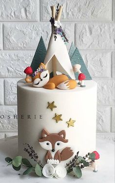 a white cake decorated with animals and stars