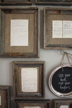 several frames with writing on them hanging from the wall