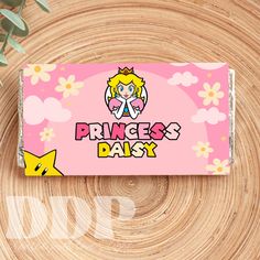 the princess daisy candy bar is sitting on top of a wooden table next to some flowers