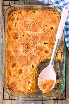 a casserole in a glass dish with a spoon on the side and a blue checkered napkin