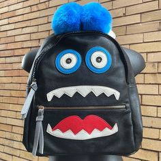 Under One Sky Monster Black Face Backpack With Adjustable Straps (Still Wrapped) And Several Compartments With 2 Cute Pom Poms On Top Length 14 Width 14 Depth 5.5 Trendy Black Leather Backpack, Trendy Black Backpack For Back To School, Fun Travel Backpack With Zipper Closure, Back To School Black Leather Bags, Black Leather Bags For Back To School, Black Leather Backpack For Back To School, Black Leather Backpack With Adjustable Strap For School, Black Leather Backpack For School With Zipper Closure, Casual Black Backpack With Removable Pouch