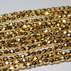 three strands of gold colored glass beads