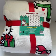 the hello kitty blanket is wrapped in white and red