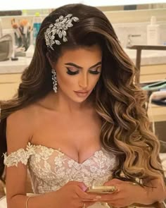 a beautiful woman in a wedding dress with long hair and a tiara on her head