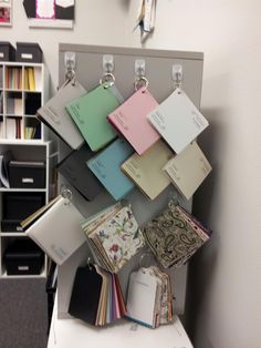 there are many folders hanging on the wall next to each other in this office