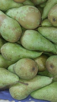 a pile of green pears sitting on top of each other